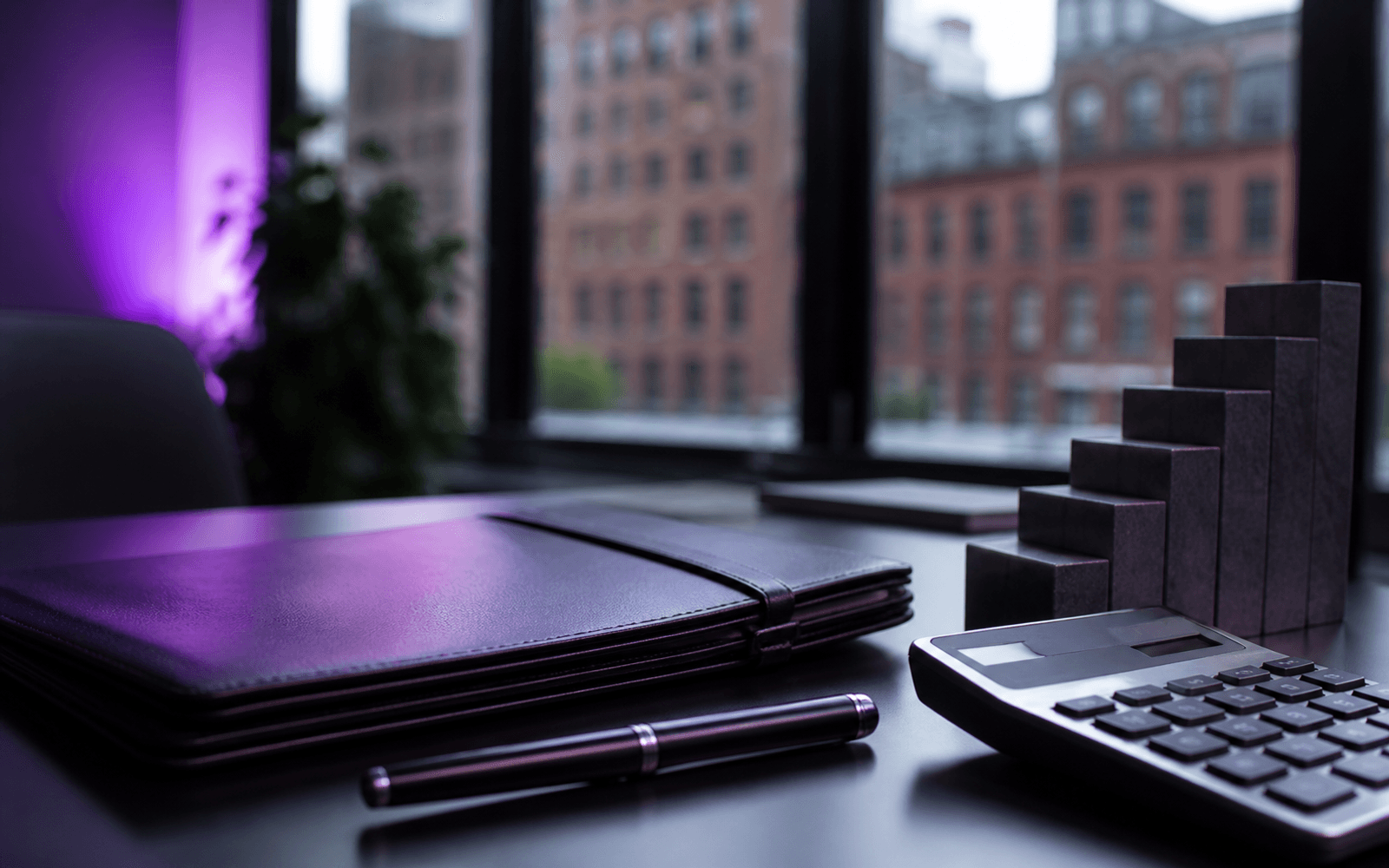 Purple business portfolio and stepped planning blocks on a Boston office desk